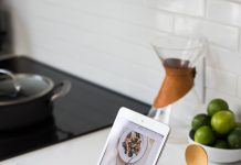 Tablet with a recipe open on it sitting on a white counter